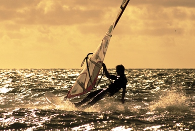 Pictured is a windsurfer freestyling off the island of Anrum in the German North Sea.  Photo by H C Merkle of Stuttgart, Germany.